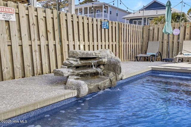 view of swimming pool featuring fence and a fenced in pool