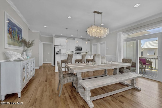 dining area featuring light wood-style floors, recessed lighting, and crown molding