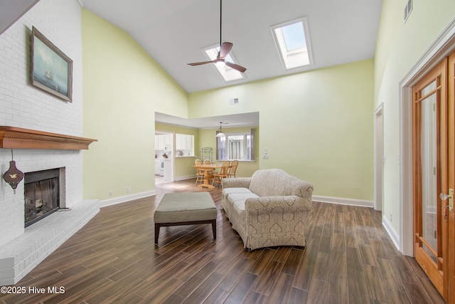 living area with visible vents, baseboards, dark wood-style floors, a brick fireplace, and high vaulted ceiling