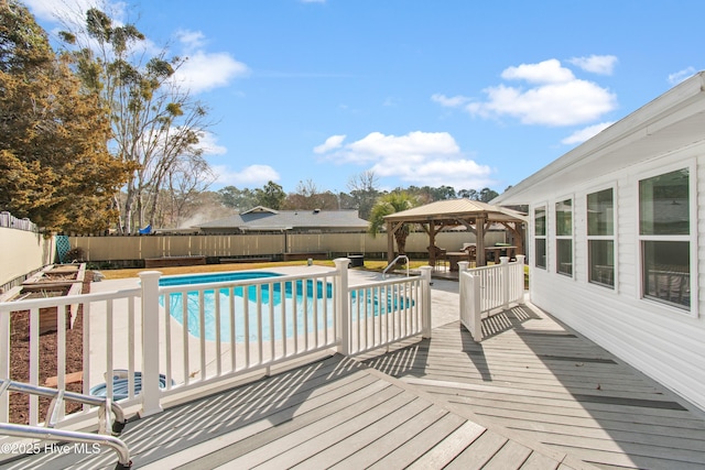 wooden terrace featuring a gazebo, a fenced backyard, and a fenced in pool