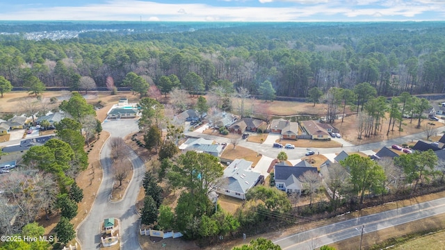 birds eye view of property featuring a residential view and a view of trees