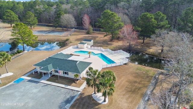 drone / aerial view with a water view and a wooded view