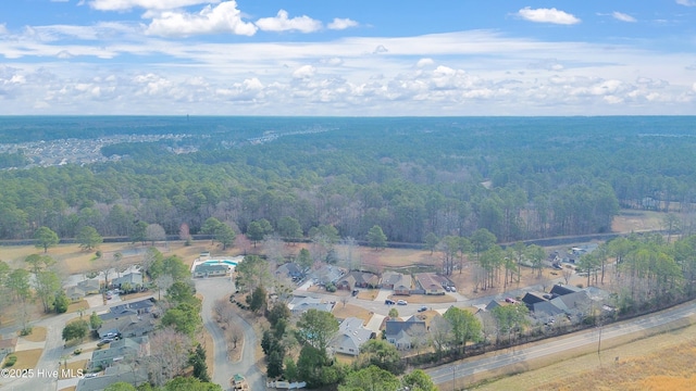 birds eye view of property featuring a wooded view