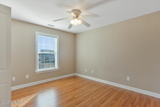 unfurnished room with ceiling fan and light wood-type flooring