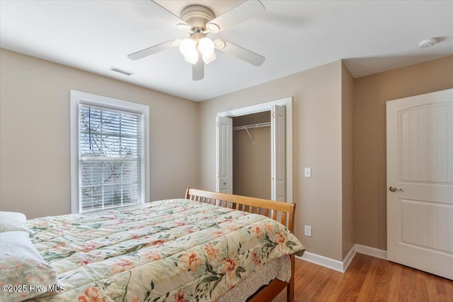 bedroom featuring a closet, ceiling fan, and light hardwood / wood-style flooring