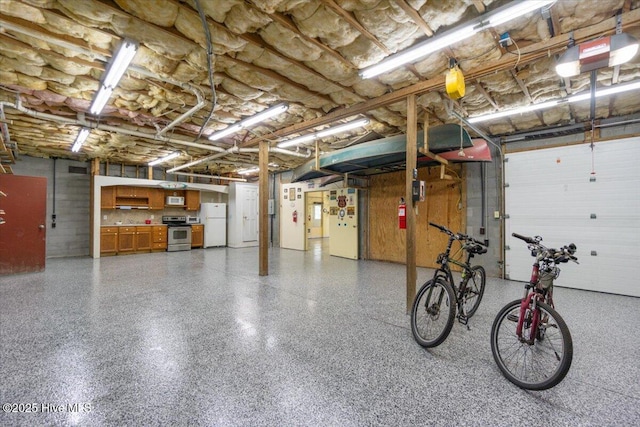 garage featuring a garage door opener and white refrigerator