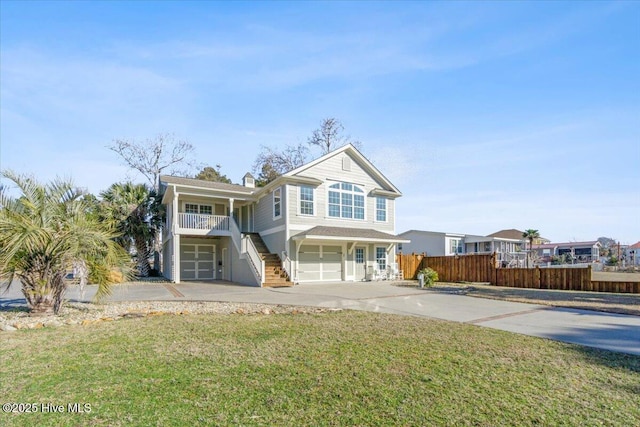 view of front of property with a garage and a front lawn