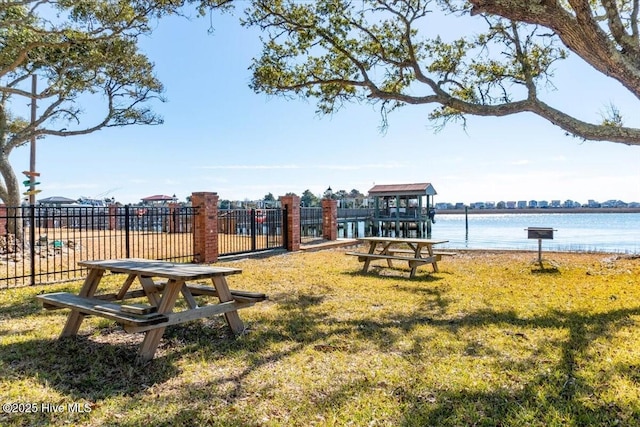 view of property's community featuring a yard and a water view