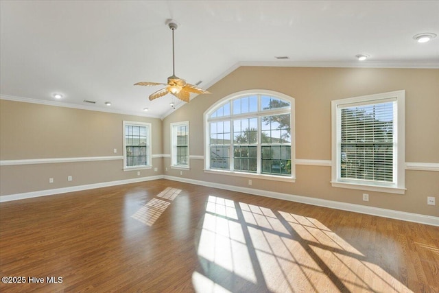 empty room with lofted ceiling, wood-type flooring, ornamental molding, and ceiling fan