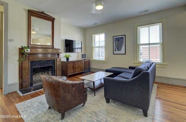 living room with a premium fireplace and light hardwood / wood-style floors