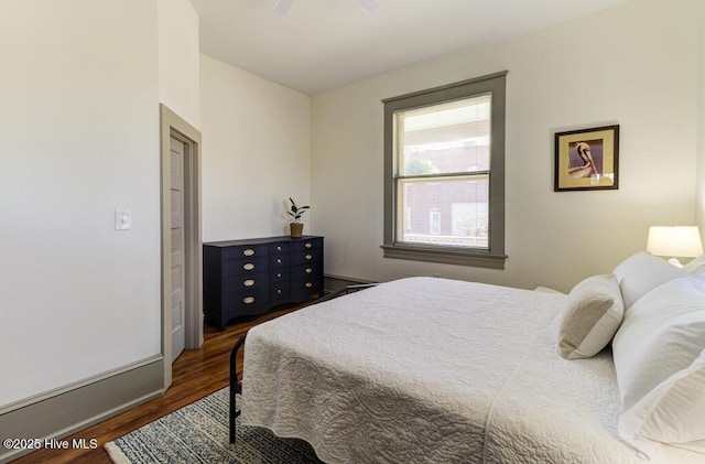 bedroom featuring dark hardwood / wood-style flooring and ceiling fan