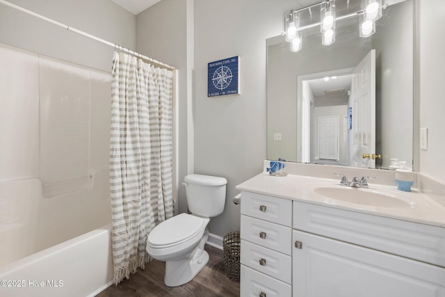 full bathroom featuring hardwood / wood-style flooring, vanity, shower / tub combo with curtain, and toilet