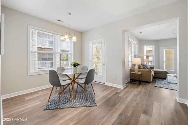 dining room with an inviting chandelier and hardwood / wood-style flooring