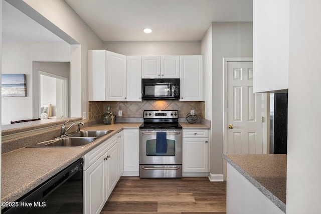 kitchen featuring sink, white cabinets, backsplash, black appliances, and dark wood-type flooring