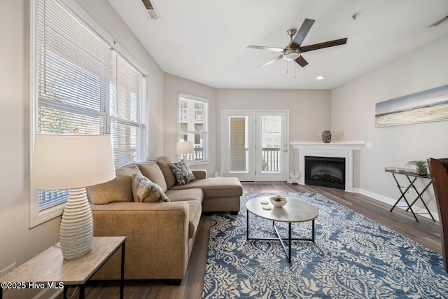 living room featuring dark hardwood / wood-style floors and ceiling fan