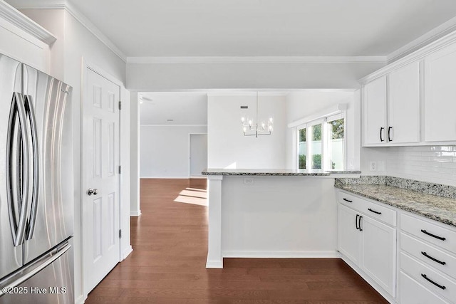 kitchen with ornamental molding, white cabinets, dark hardwood / wood-style flooring, and stainless steel fridge