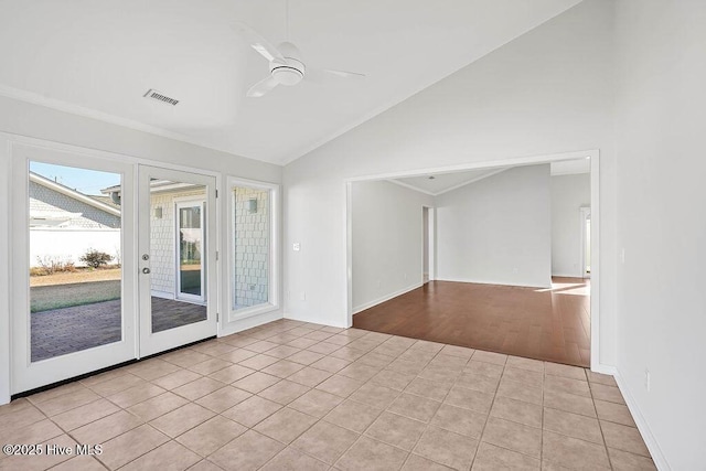 tiled empty room with high vaulted ceiling and ceiling fan