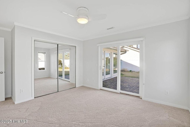 unfurnished bedroom with crown molding, access to exterior, and light colored carpet