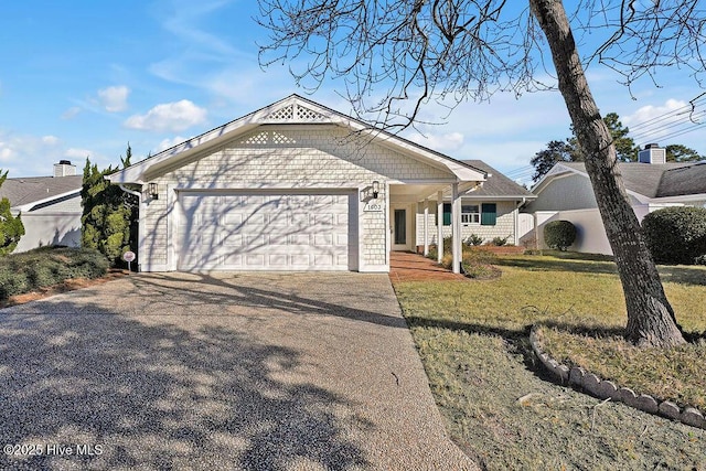 ranch-style home featuring a front yard and a garage