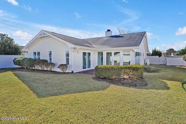 back of house with a lawn