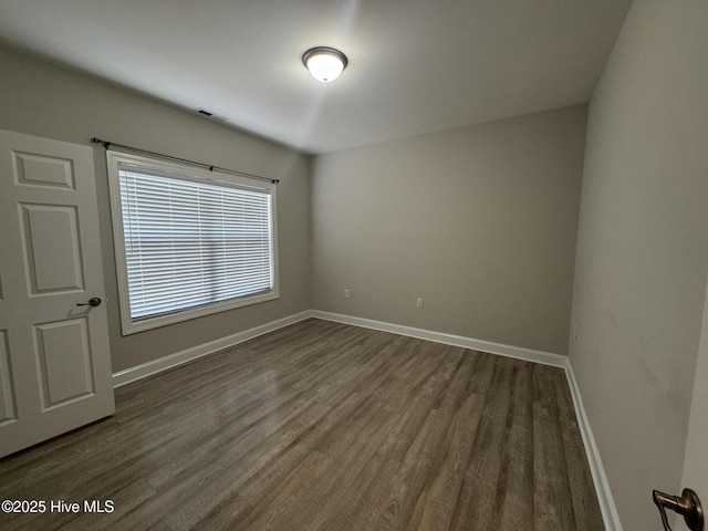 empty room featuring dark wood-type flooring