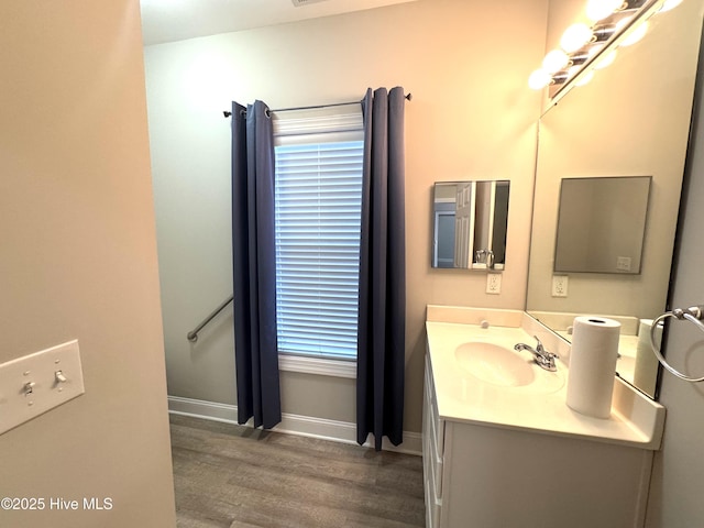 bathroom with vanity and wood-type flooring