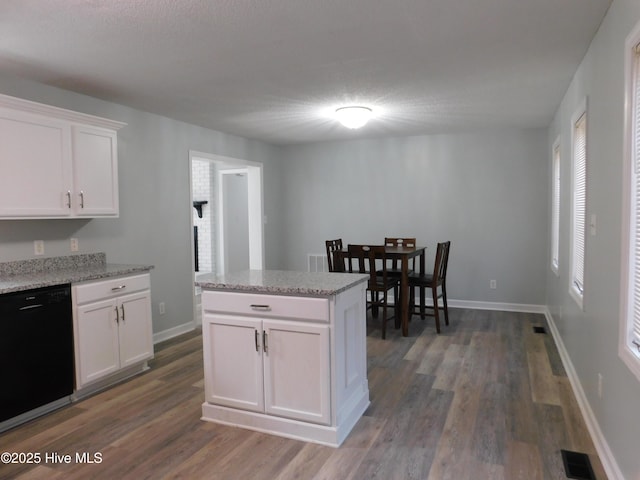 kitchen featuring a textured ceiling, dark hardwood / wood-style floors, black dishwasher, light stone countertops, and white cabinets