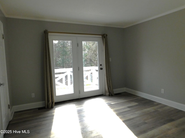 entryway with ornamental molding, baseboards, and wood finished floors
