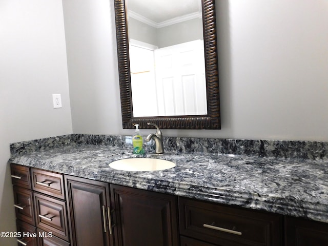 bathroom with vanity and ornamental molding