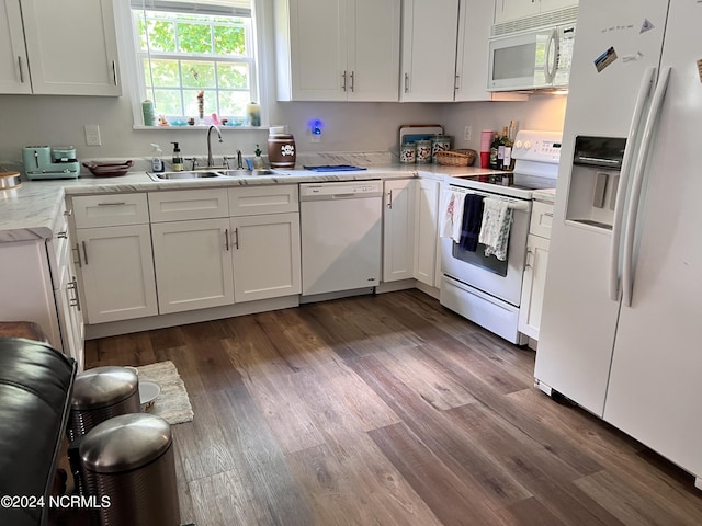 kitchen featuring sink, white cabinetry, dark hardwood / wood-style flooring, white appliances, and light stone countertops