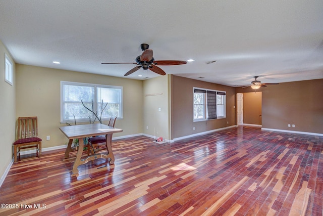 interior space featuring ceiling fan, a healthy amount of sunlight, wood-type flooring, and a textured ceiling