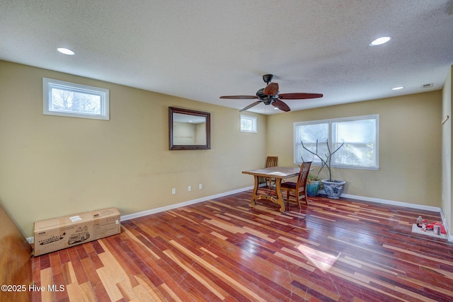 misc room featuring hardwood / wood-style flooring, ceiling fan, a textured ceiling, and a wealth of natural light