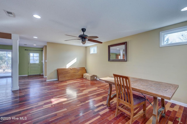 dining room featuring dark hardwood / wood-style floors, a textured ceiling, and ceiling fan