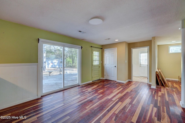 interior space with wood-type flooring and a textured ceiling