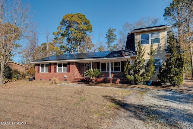 view of front of house with a front yard and solar panels