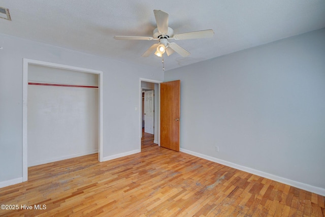 unfurnished bedroom featuring a closet, ceiling fan, and light hardwood / wood-style flooring