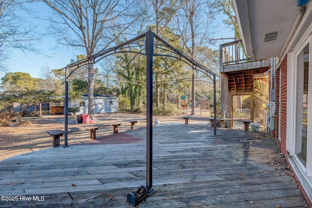 wooden terrace featuring an outbuilding