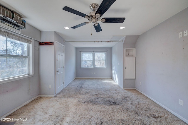 interior space with light carpet and ceiling fan