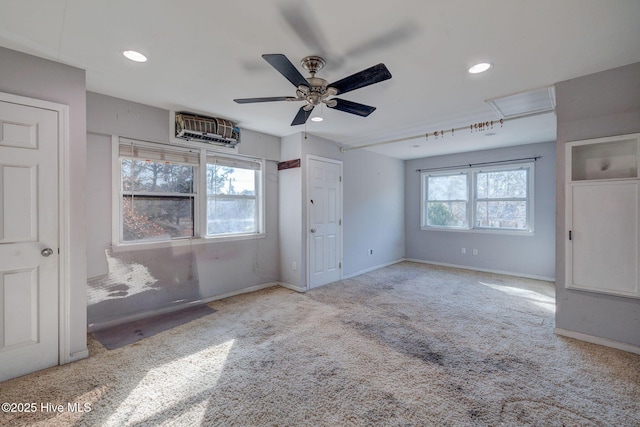 unfurnished bedroom featuring multiple windows, light colored carpet, and ceiling fan