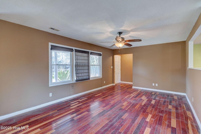 spare room featuring ceiling fan, hardwood / wood-style floors, and a textured ceiling