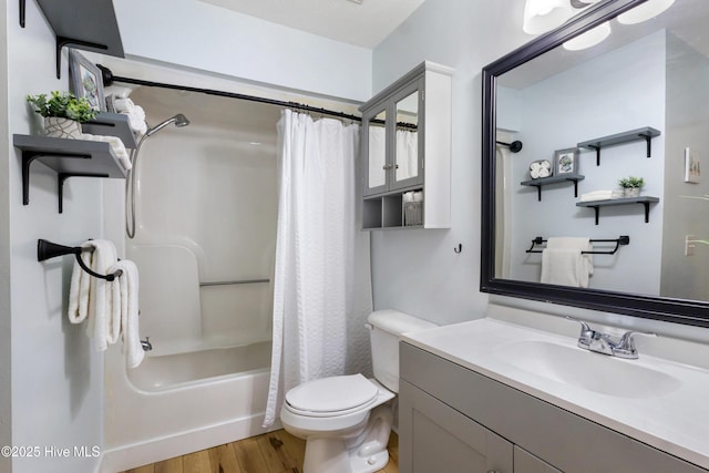 full bathroom featuring hardwood / wood-style flooring, vanity, toilet, and shower / bath combo