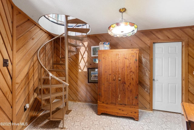 staircase featuring wood walls