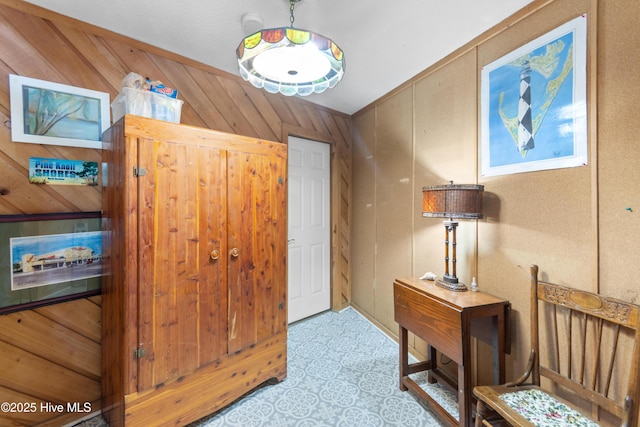 foyer entrance featuring wood walls