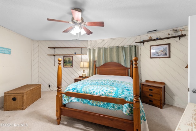 carpeted bedroom featuring a textured ceiling and a ceiling fan