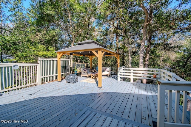 114 White Ash Dr, Pine Knoll Shores, NC 28512 - deck featuring a gazebo, an outdoor hangout area, and view of wooded area