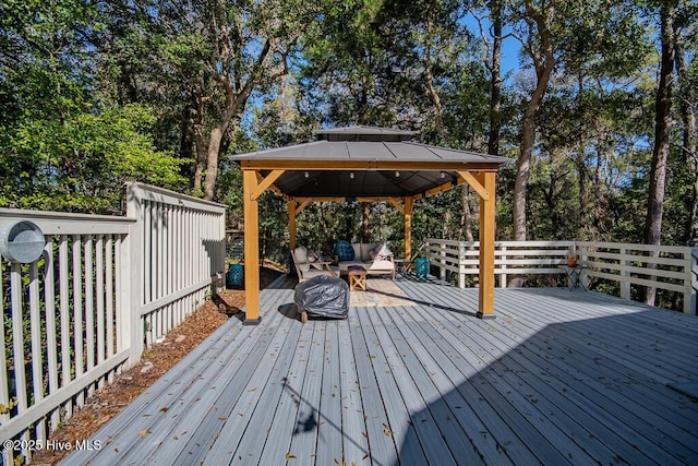 wooden deck with a gazebo and an outdoor living space