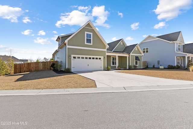 view of front of home with a garage, fence, and concrete driveway