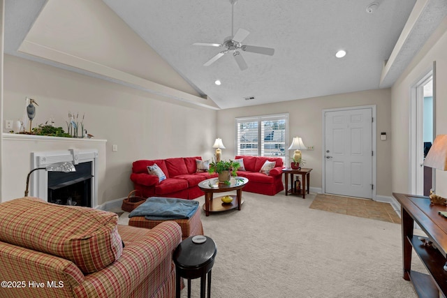 carpeted living room featuring ceiling fan, lofted ceiling, and a textured ceiling