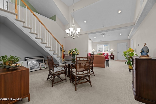 carpeted dining area with a notable chandelier and a high ceiling