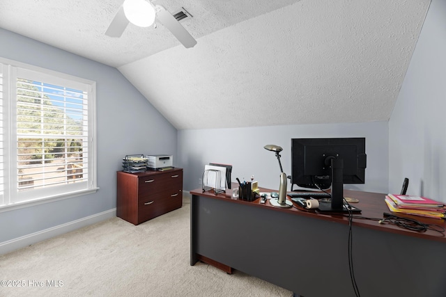 carpeted office featuring a textured ceiling, vaulted ceiling, and ceiling fan